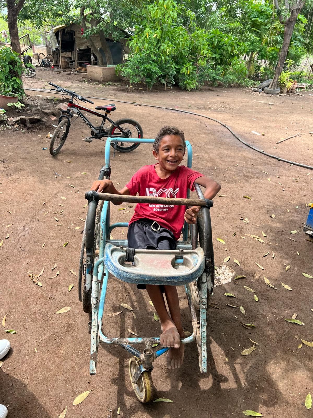 Jose David, a participant in the Special Needs Program, smiling outdoors