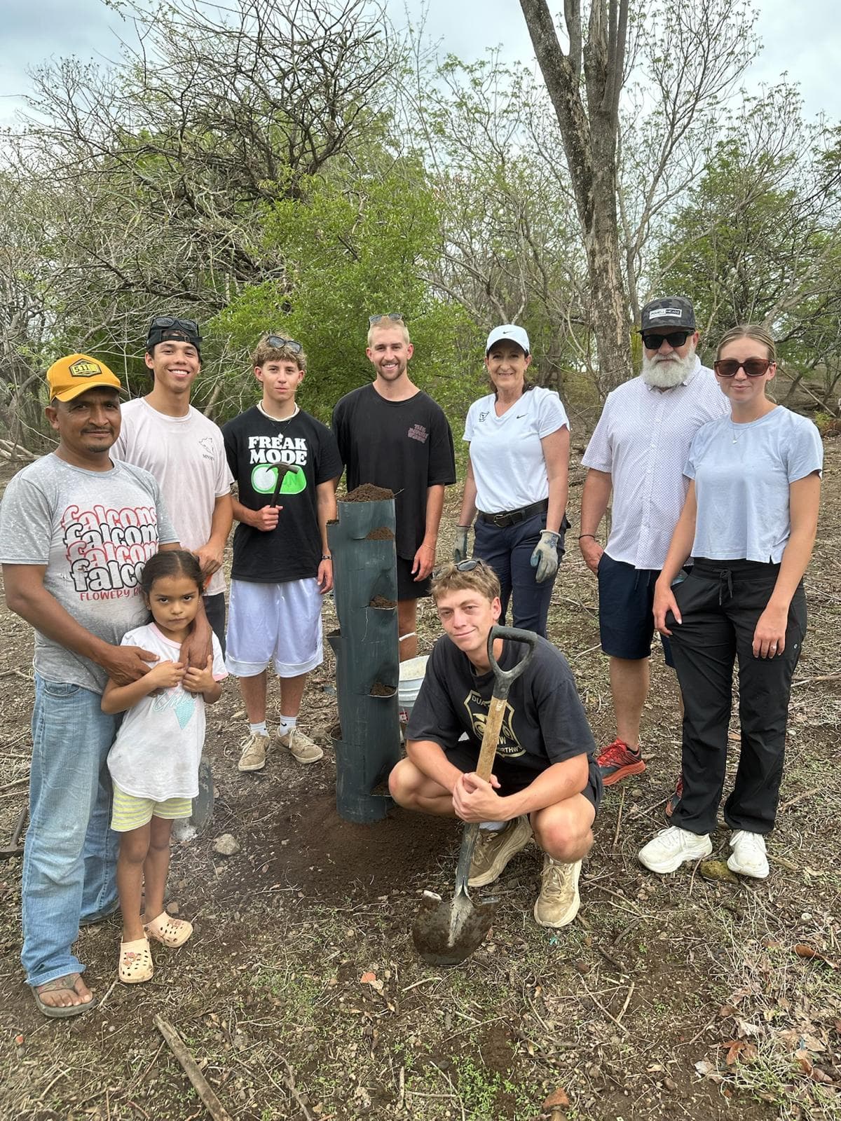 Volunteers installing a vertical greening system with a local family